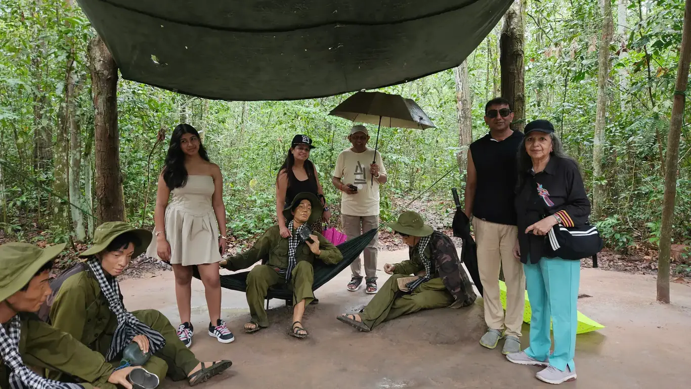 bookvietnamholiday.com clients exploring Cu Chi Tunnels