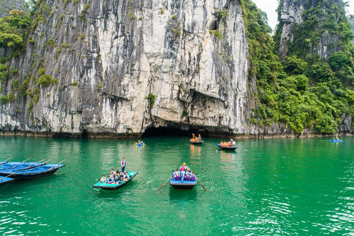 Kayaking through hidden lagoon limestone cave Lan Ha Bay Cat Ba Vietnam