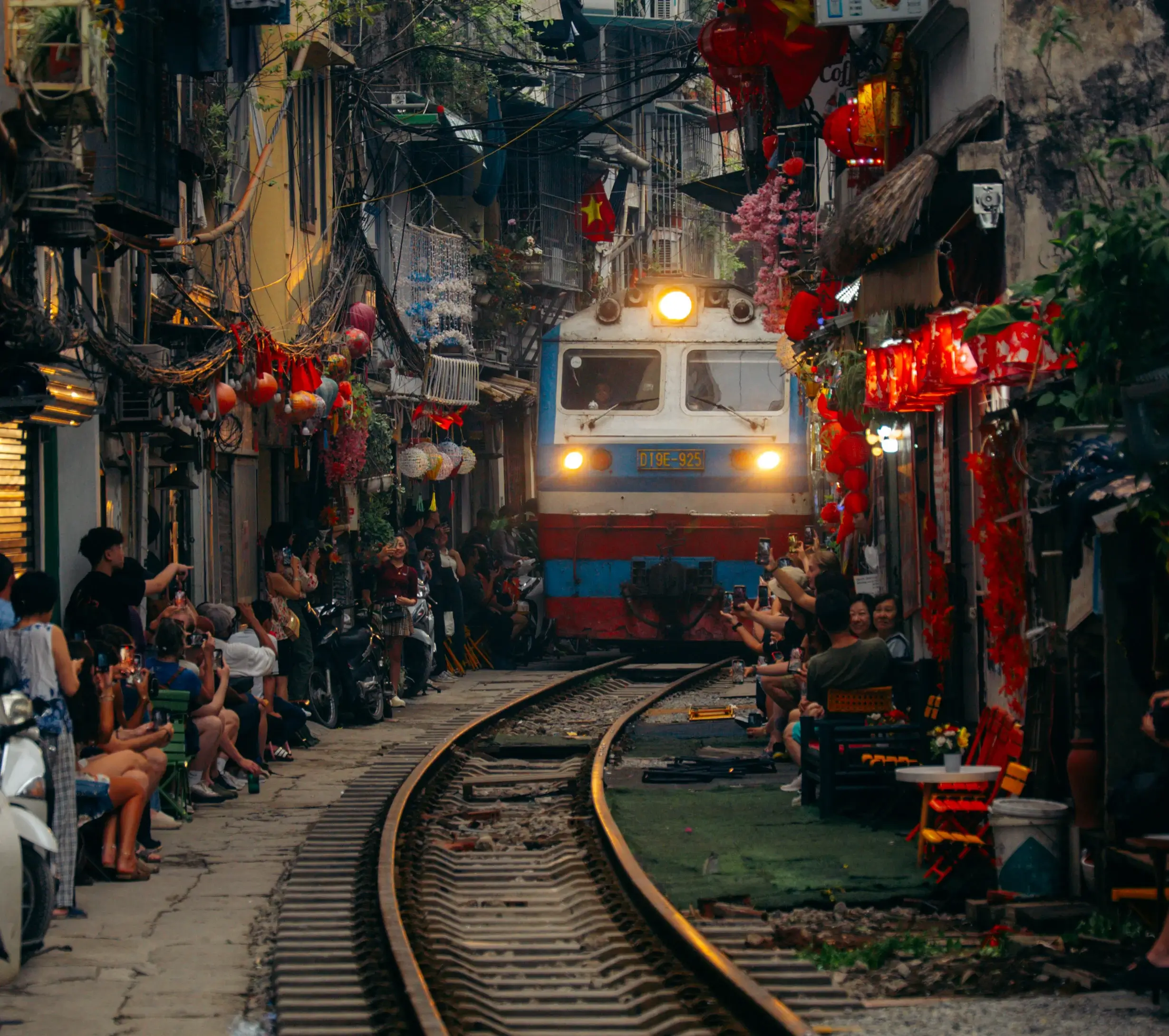 Train passing through Train Street Hanoi café lane