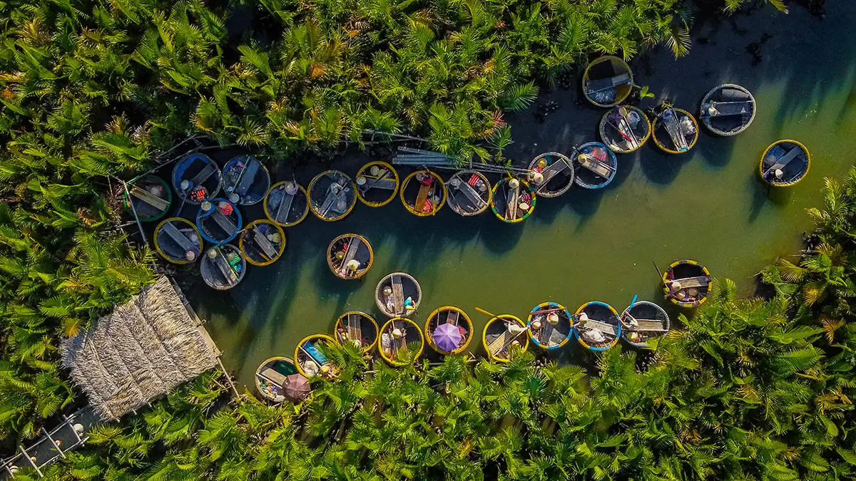 Traditional basket boat ride in Bay Mau coconut palm forest Hoi An Vietnam