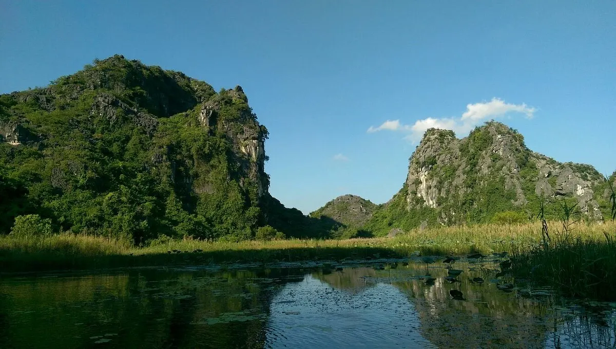 Van Long wetland nature reserve bamboo boat ride karsts Vietnam