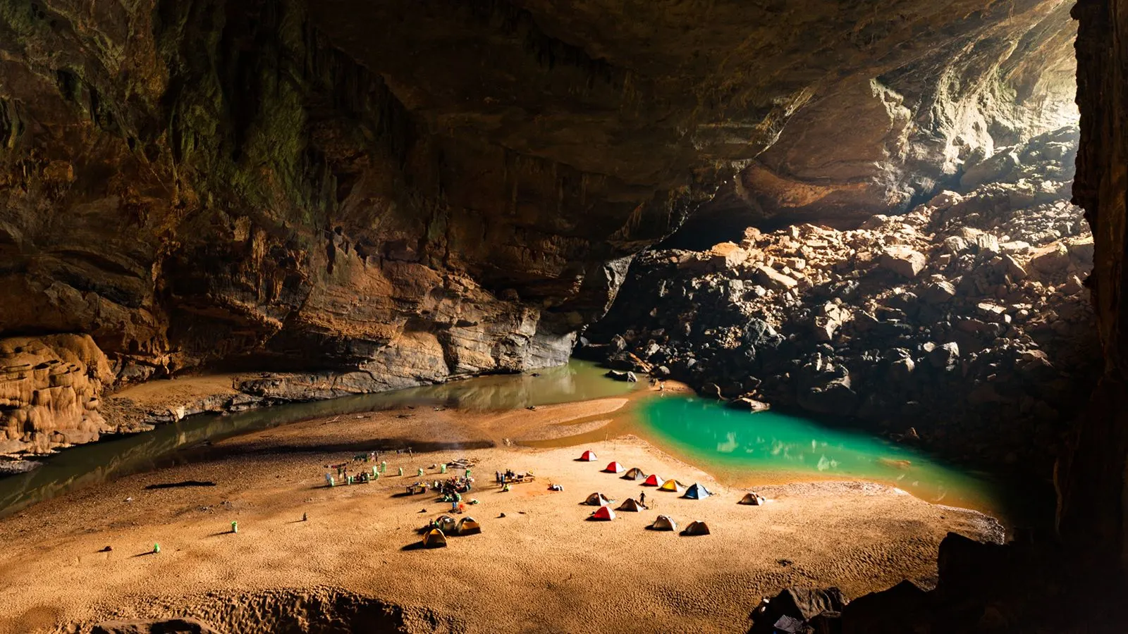 Son Doong Cave interior vast chamber with internal jungle sunbeam Phong Nha Vietnam