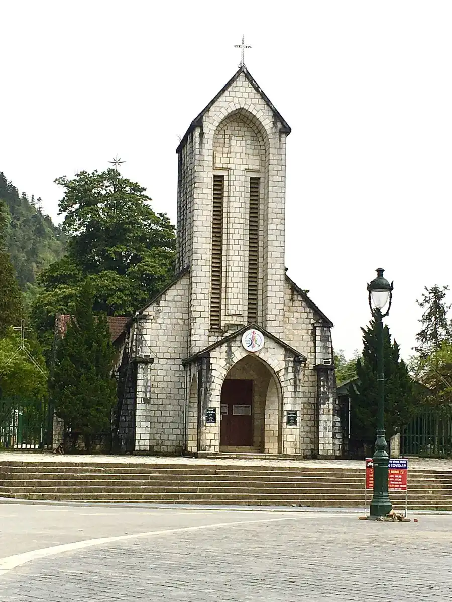 Sapa stone church French colonial and town square mountain fog Vietnam